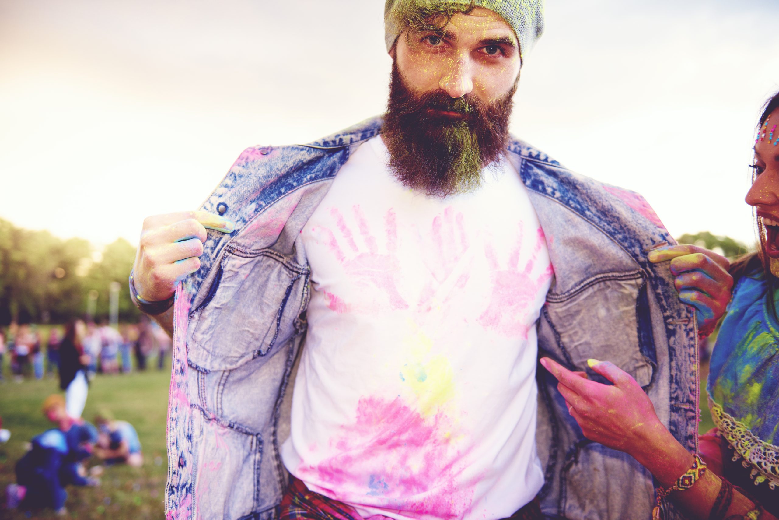 Portrait of young male hipster with chalk handprints on tshirt at festival